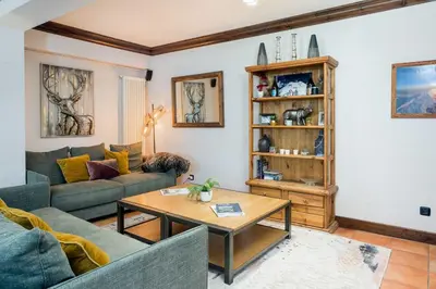 a living room with a couch and a table at Pothecary apartment -Chamonix All Year in Chamonix-Mont-Blanc