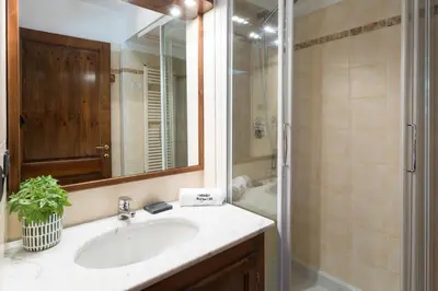 a bathroom with a sink and a shower at Pothecary apartment -Chamonix All Year in Chamonix-Mont-Blanc