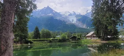 a lake with a mountain in the background at Grand studio près Lac Gaillands in Chamonix-Mont-Blanc