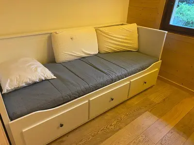 a bed with two pillows on it in a room at Appartement exceptionnel au Lavancher à chamonix in Chamonix-Mont-Blanc