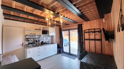 a kitchen with white cabinets and a counter top at Studio 181 in Combloux