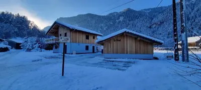a couple of wooden buildings with snow on them at Appart 3 pièces Cosy - idéal famille & sports Le Cairn De Samoëns in Samoëns