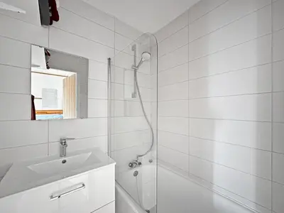 a white bathroom with a shower and a sink at BB222 - Appartement 6 pers pied de pistes in Les Carroz d'Araches