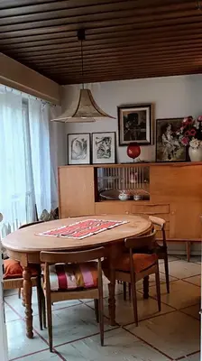 a dining room with a wooden table and chairs at Maison idéalement située toutes mobilités in Saint-Gervais-les-Bains