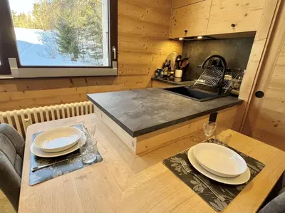 a kitchen with a sink and a table with plates on it at Appartement Studio, 2 couchages, MEGEVE MEG400-T122 in Megève