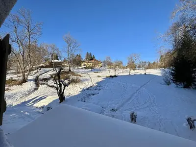 a snow covered field with a house in the background at Appartement Studio, 2 couchages, MEGEVE MEG400-T122 in Megève
