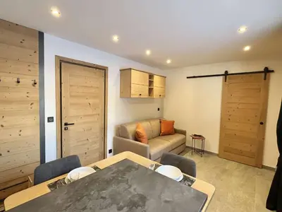 a living room with a table and a couch at Appartement Studio, 2 couchages, MEGEVE MEG400-T122 in Megève