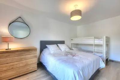 a bedroom with a bed and a mirror and a dresser at Open the door and Hike, Ski or Bike 3 Br Apartment Saint Gervais in Saint-Gervais-les-Bains
