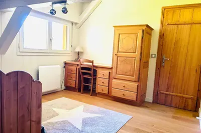 a room with a desk and a dresser and a window at Spacious chalet in Chamonix with Mont Blanc view in Chamonix-Mont-Blanc