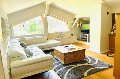 a living room with a white couch and a coffee table at Spacious chalet in Chamonix with Mont Blanc view in Chamonix-Mont-Blanc