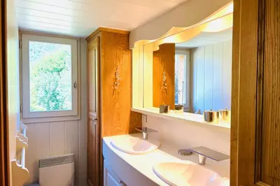 a bathroom with two sinks and a mirror at Spacious chalet in Chamonix with Mont Blanc view in Chamonix-Mont-Blanc
