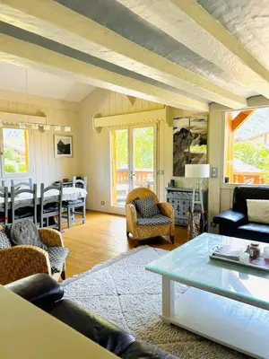 a living room with a couch and a table at Spacious chalet in Chamonix with Mont Blanc view in Chamonix-Mont-Blanc