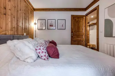 a bedroom with a bed with pillows on it at T3 Argentière in Chamonix-Mont-Blanc