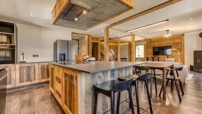 a kitchen with wooden cabinets and a counter top at Chalet Follette in Chamonix-Mont-Blanc