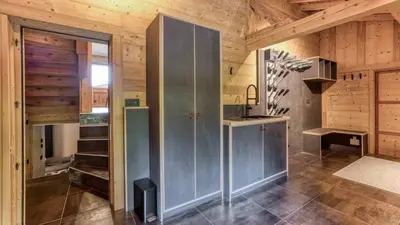 a kitchen with wood ceilings and stainless steel appliances at Chalet Follette in Chamonix-Mont-Blanc