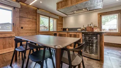 a kitchen with a wooden table and chairs at Chalet Follette in Chamonix-Mont-Blanc