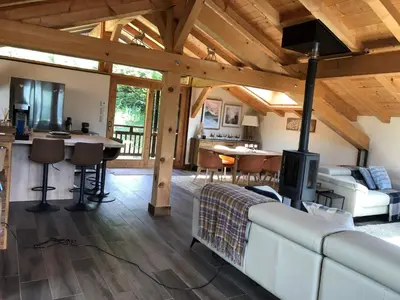 a living room with a white couch and a fireplace at Beautiful chalet with panoramic views in Samoens walking distance to the village in Samoëns