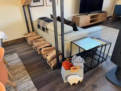 a living room with a couch and a tv at Beautiful chalet with panoramic views in Samoens walking distance to the village in Samoëns