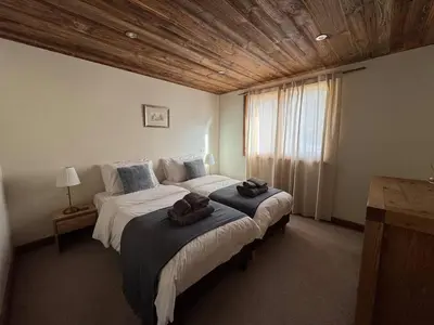 a bedroom with a large bed with towels on it at Beautiful chalet with panoramic views in Samoens walking distance to the village in Samoëns