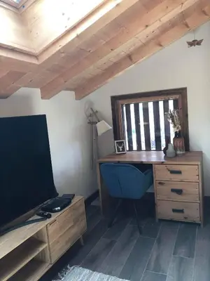 a room with a wooden desk and a wooden dresser at Beautiful chalet with panoramic views in Samoens walking distance to the village in Samoëns