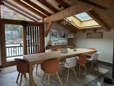 a dining room with a large wooden table and chairs at Beautiful chalet with panoramic views in Samoens walking distance to the village in Samoëns