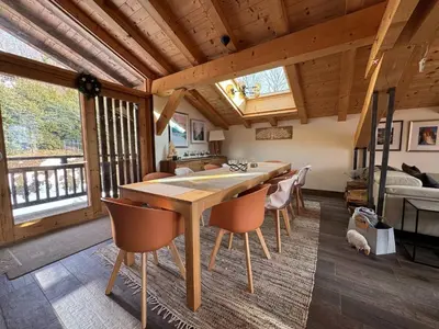 a dining room with a wooden table and chairs at Beautiful chalet with panoramic views in Samoens walking distance to the village in Samoëns