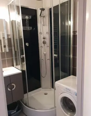 a bathroom with a shower and a washing machine at Au pied des pistes Studio 4 personnes in Morillon