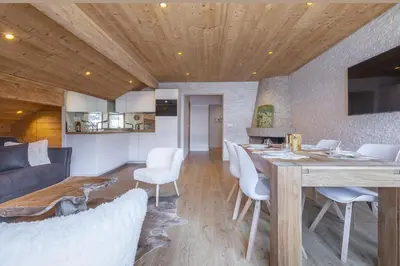 a dining room and living room with a table and chairs at Résidence Le Panorama - Megève in Megève