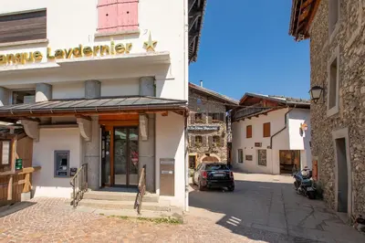 a building with a sign on the side of a street at Résidence Le Panorama - Megève in Megève