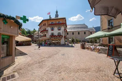 a cobblestone street in a town with a building at Résidence Le Panorama - Megève in Megève