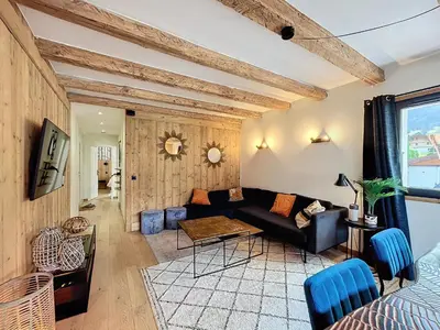 a living room with a couch and a table at Appartement Alpage in Les Houches