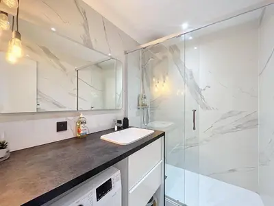 a bathroom with a sink and a shower at Appartement Alpage in Les Houches