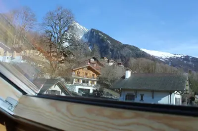 a view from a window of a house in the mountains at La Ferme de Sous-Lachat in Samoëns