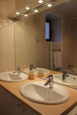 a bathroom with three sinks and a large mirror at La Ferme de Sous-Lachat in Samoëns