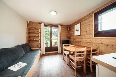 a living room with a couch and a table at Studio Lanchettes - Your stay at the gates of Megève in Demi-Quartier