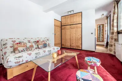 a living room with a couch and a table at Apartment l'Aiguille, au pied des télécabines in Chamonix-Mont-Blanc