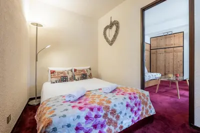 a bedroom with a bed and a large mirror at Apartment l'Aiguille, au pied des télécabines in Chamonix-Mont-Blanc