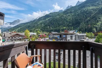 a balcony with a view of a town and mountains at Apartment l'Aiguille, au pied des télécabines in Chamonix-Mont-Blanc
