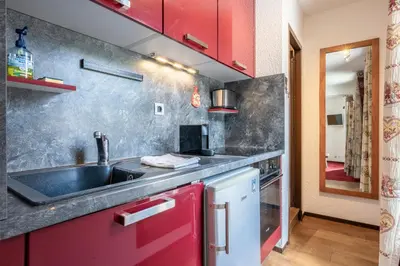 a kitchen with a sink and a red cabinet at Apartment l'Aiguille, au pied des télécabines in Chamonix-Mont-Blanc