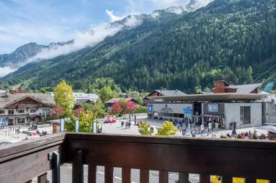 a view from a balcony of a town with a mountain at Apartment l'Aiguille, au pied des télécabines in Chamonix-Mont-Blanc