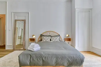 a bedroom with a large bed and a mirror at Majestic Chamonix in Chamonix-Mont-Blanc