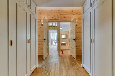 a hallway with white doors and wooden walls at Majestic Chamonix in Chamonix-Mont-Blanc