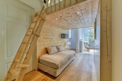 a bedroom with a loft bed with a ladder at Majestic Chamonix in Chamonix-Mont-Blanc