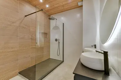 a bathroom with a sink and a glass shower at Majestic Chamonix in Chamonix-Mont-Blanc
