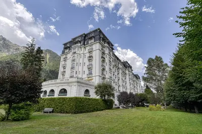 a large white building with a park in front of it at Majestic Chamonix in Chamonix-Mont-Blanc