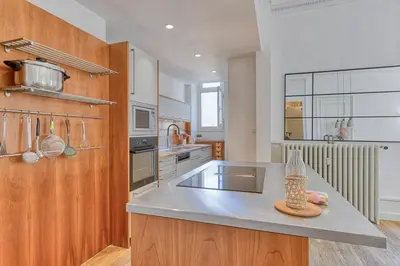 a large kitchen with a counter top and a kitchen island at Majestic Chamonix in Chamonix-Mont-Blanc