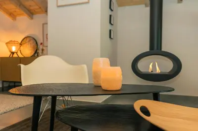 a table with two candles on top of it at Nid douillet rénové sur les pistes ski in out in Megève