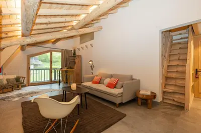 a living room with a couch and a table at Nid douillet rénové sur les pistes ski in out in Megève