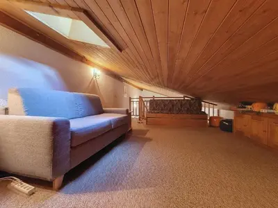 a living room with a couch and a wooden ceiling at Duplex 2 pièces avec balcon et Wifi face au Mont Blanc - FR-1-560-165 in Combloux