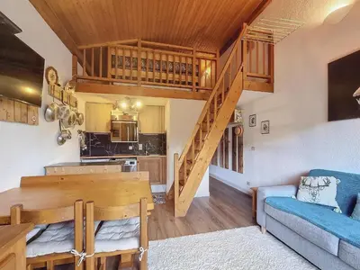 a kitchen and a living room with a spiral staircase at Duplex 2 pièces avec balcon et Wifi face au Mont Blanc - FR-1-560-165 in Combloux